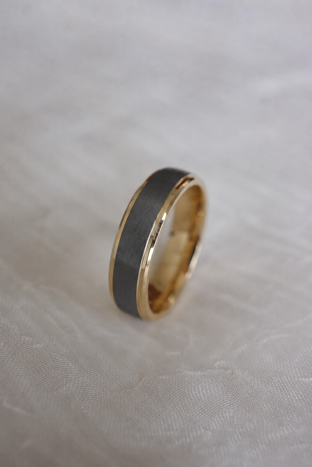 Charcoal and Gold Step Edge Band displayed upright on fabric
